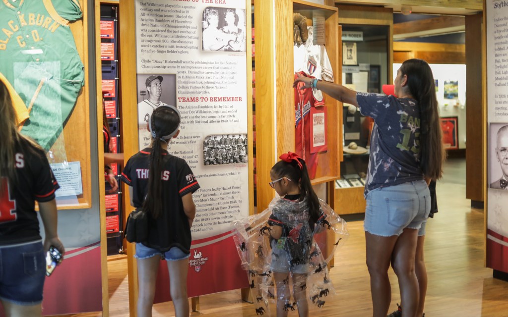 guests looking at exhibit at the National Softball Hall of Fame Museum