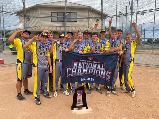 Boys Softball team posing with Trophy