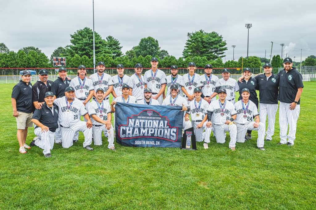 Men's Softball team posing with Trophy